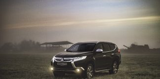 A car parked in a grassy field Description automatically generated