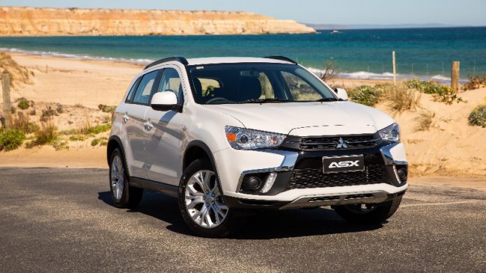 a-car-parked-on-the-side-of-a-road-description-au A car parked on the side of a road Description automatically generated