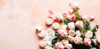 flat-lay photography of macaroons and pink rose flowers
