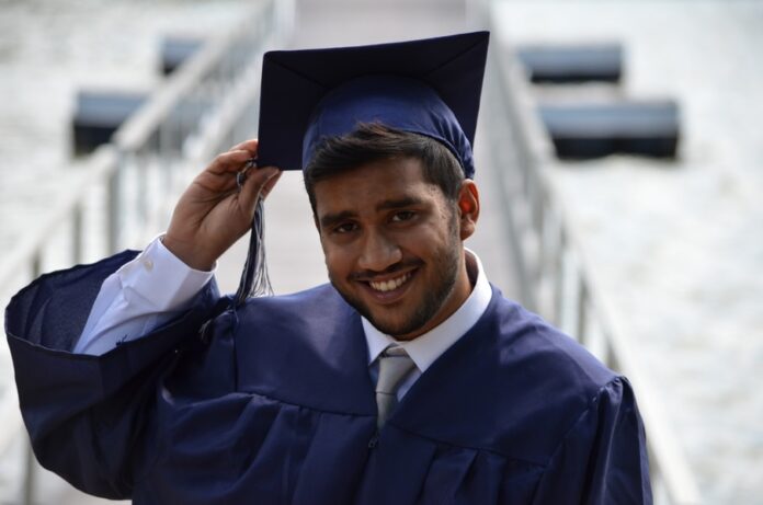Photo by Muhammad Rizwan man holding his graduation cap