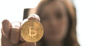 woman holding Bitcoin