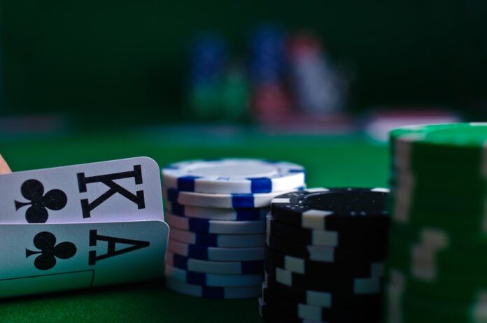 Photo by Michał Parzuchowski white and black dice on green table