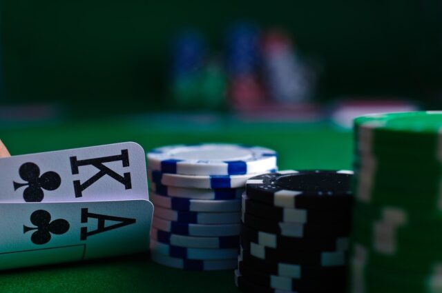 Photo by Michał Parzuchowski white and black dice on green table