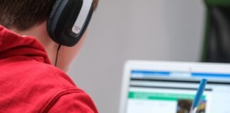 person in red shirt wearing black and gray headphones