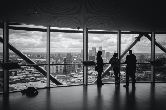 Photo by Charles Forerunner people standing inside city building