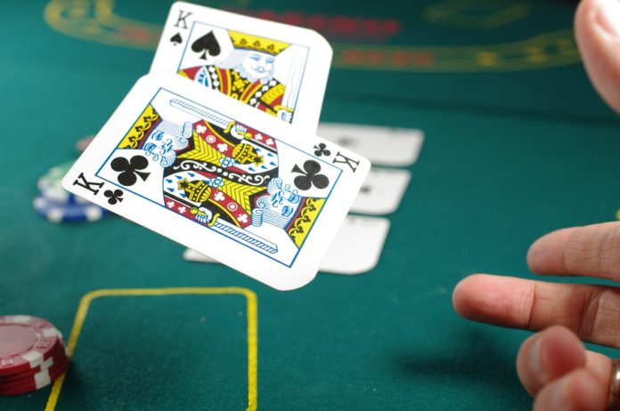Photo by Michał Parzuchowski person playing poker