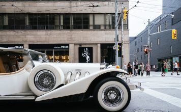 photo of classic white vehicle near pedestrian lane