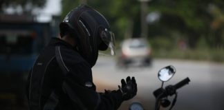 selective focus photo of man wearing motorcycle suit