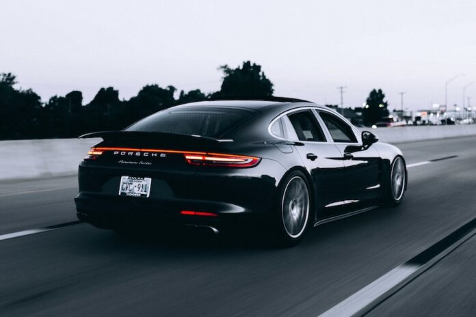 Photo by Campbell running black Porsche sedan