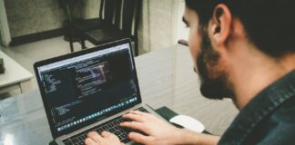 man programming using laptop