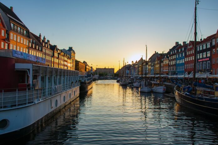 Photo by Mircea Solomiea boat on river near buildings during daytime