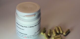 white plastic bottle with brown tablets