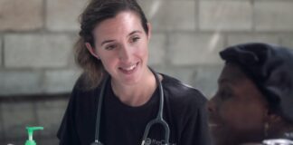 woman in black crew neck shirt wearing blue earbuds