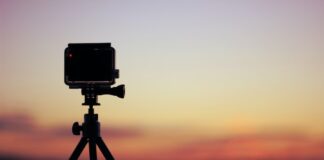 selective focus photo of black action camera on black tripod