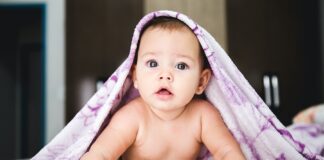 baby under purple blanket
