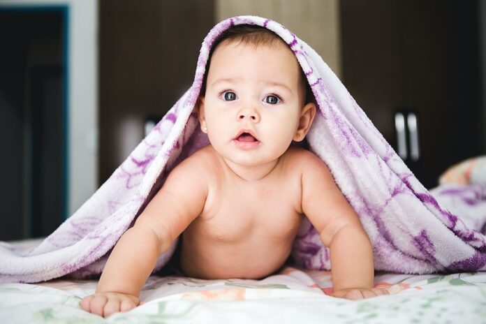 Photo by Jonathan Borba baby under purple blanket