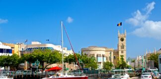 How BTC can Make a Great Impact on the Economy of Barbados? white and red boat on water near brown concrete building during daytime