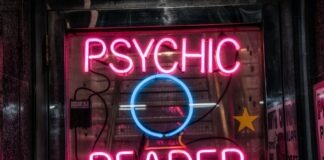 turned on red Psychic Reader neon sign