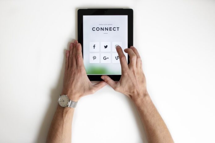 Photo by NordWood Themes person using black iPad