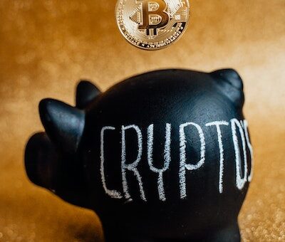 Photo by Alesia Kozik Person Putting Bitcoin in a Piggy Bank