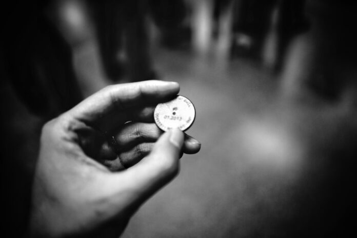 Photo by ZSun Fu grayscale photography of person holding coin