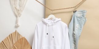 white zip up jacket hanging on brown wooden clothes hanger