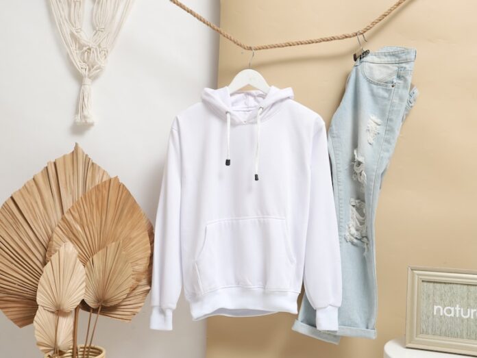 Photo by Mediamodifier white zip up jacket hanging on brown wooden clothes hanger
