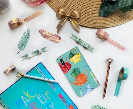 blue and white book beside white ceramic mug on white wooden table