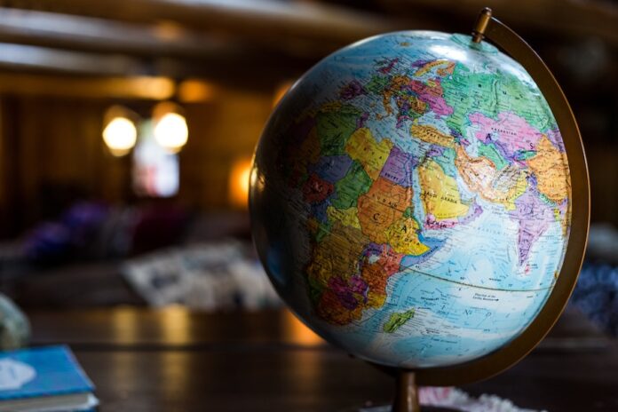 Photo by Kyle Glenn desk globe on table