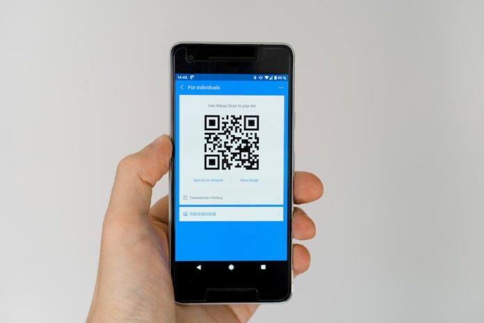 Photo by Markus Winkler black android smartphone displaying qr code