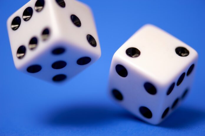 Photo by Edge2Edge Media 2 white dices on blue surface