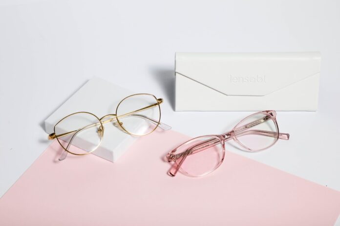 Photo by Lensabl gold framed eyeglasses on white paper