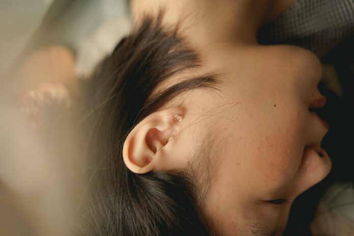 Photo by Jessica Flavia woman sleeping on white textile