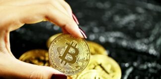Easy Steps: Buying BTC with Credit in UK gold round coin on persons hand