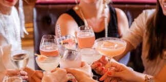 woman in black tank top holding clear wine glass