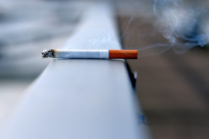 Photo by Andres Siimon white cigarette stick on white wall