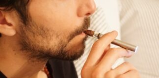 man in black shirt smoking cigarette
