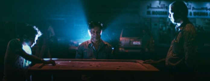 man standing on side of table film still