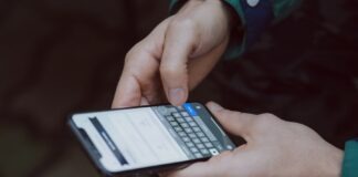selective focus photography of person using smartphone