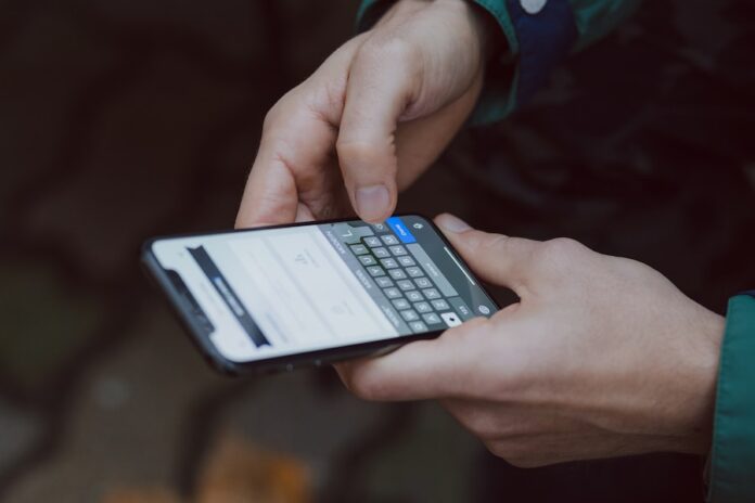 Photo by freestocks selective focus photography of person using smartphone