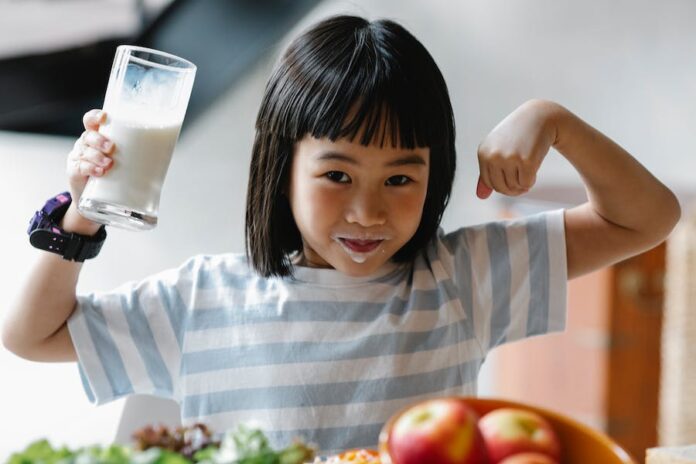 Photo by Alex Green Asian girl with milk on lips