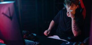 A Man in Black Shirt Using a Computer