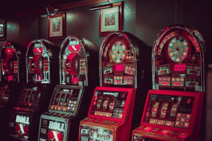 A row of slot machines Description automatically generated