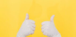 person in white long sleeve shirt doing thumbs up sign