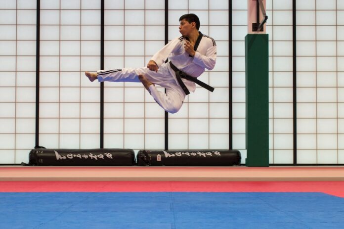 Photo by Uriel Soberanes man doing karate stunts on gym