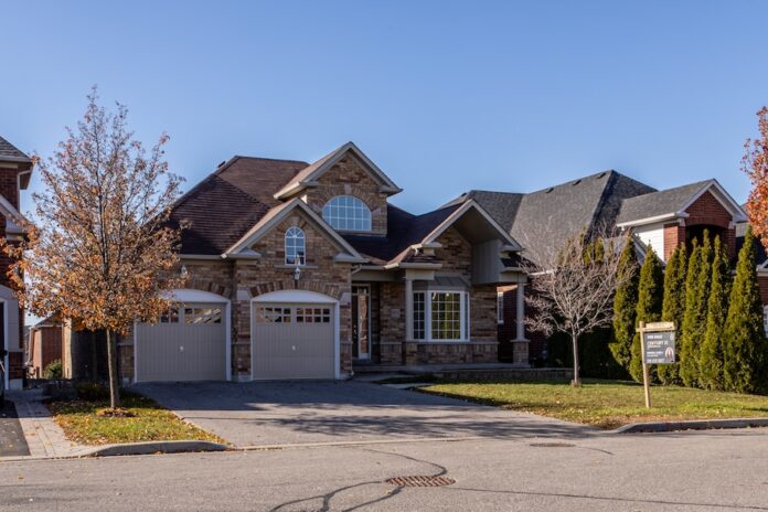 Photo by Dillon Kydd brown and white wooden house near green trees under blue sky during daytime