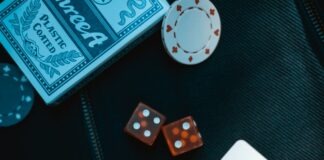 two orange dice on black surface