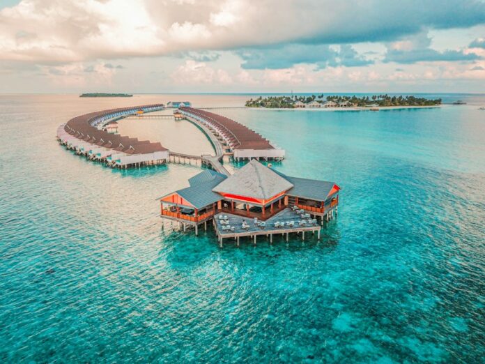 Photo by Rayyu Maldives aerial photography of resort rooms and island