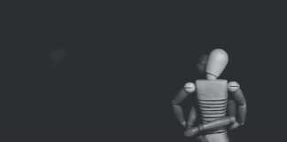 grayscale photo of joint action figure hugging one another