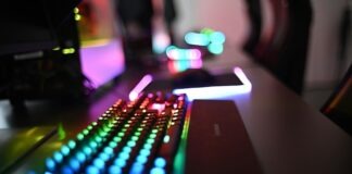 a close up of a computer keyboard with colorful lights